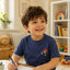 Kind trägt blaues Pumuckl Kinder-T-Shirt mit kleinem Pumuckl-Stick auf der Brust
