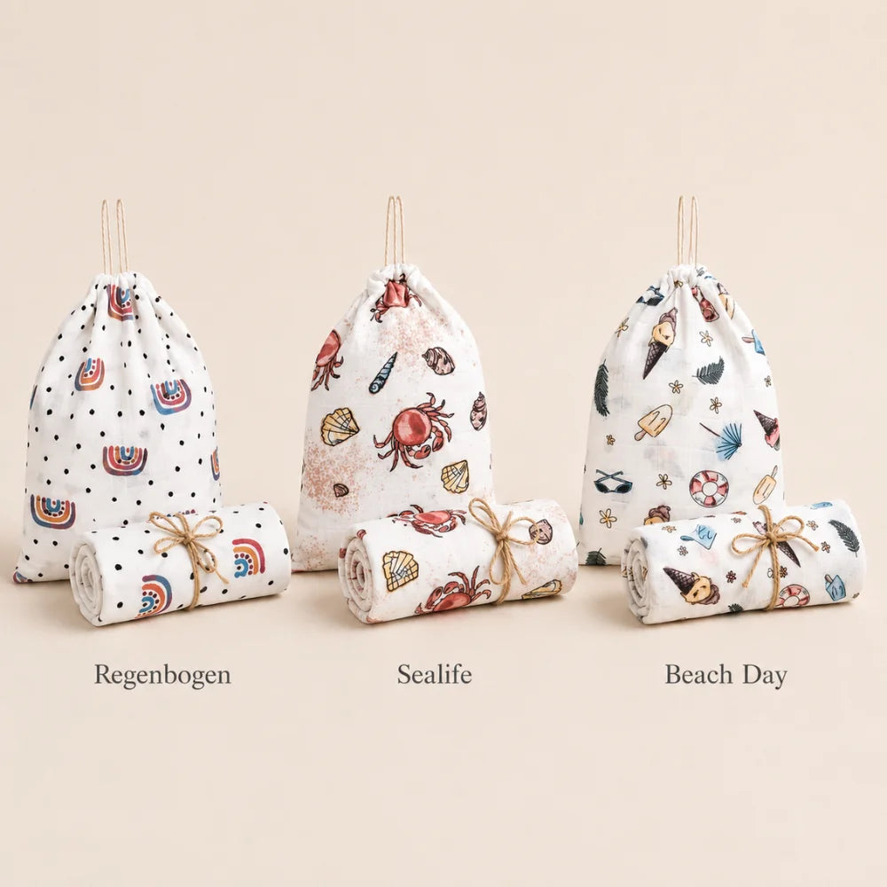 Drei Geschenk-Bundles Mulltücher in den Designs Regenbogen, Sealife und Beach Day